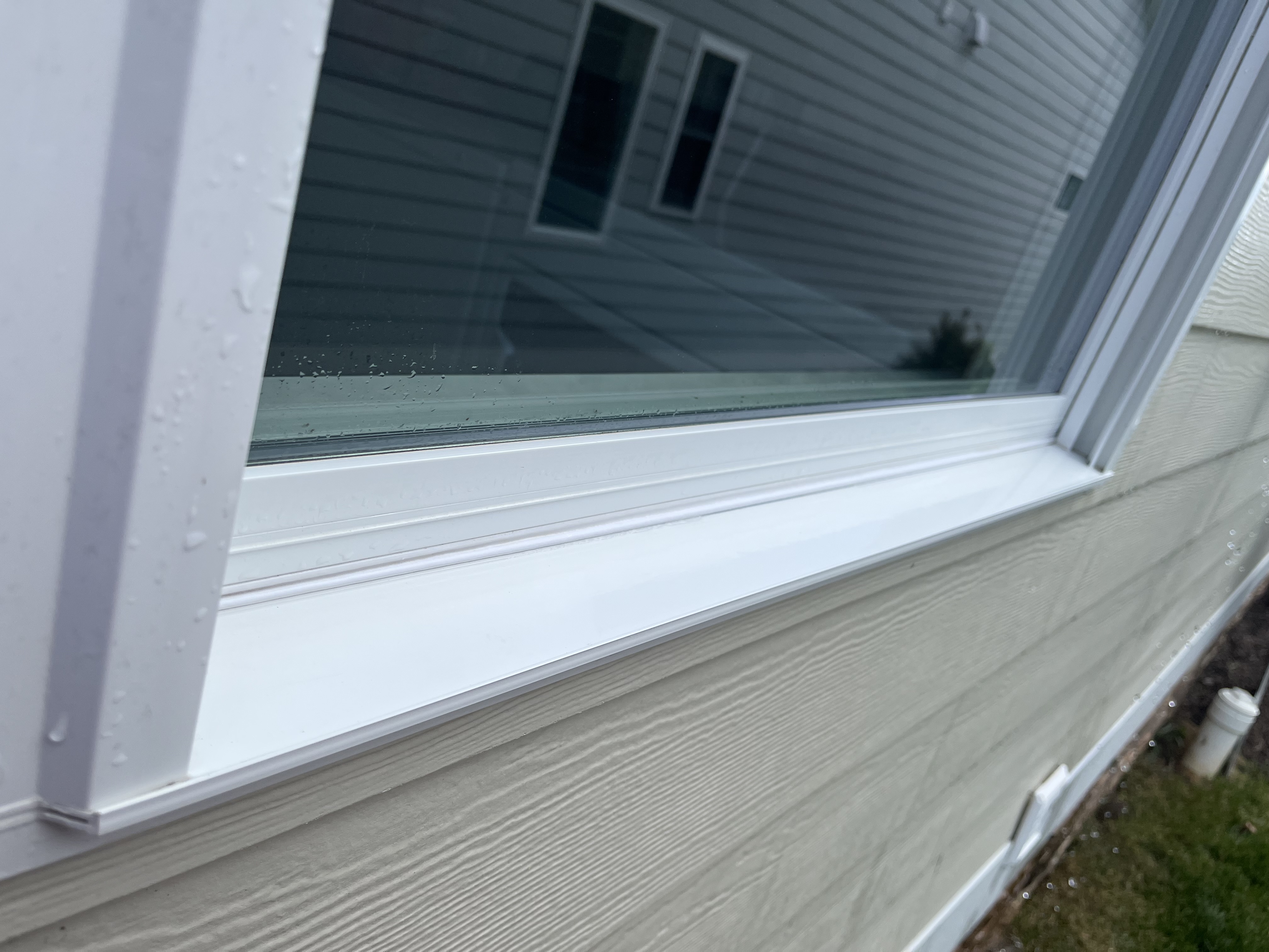 Spotless white window track after professional track detailing service
